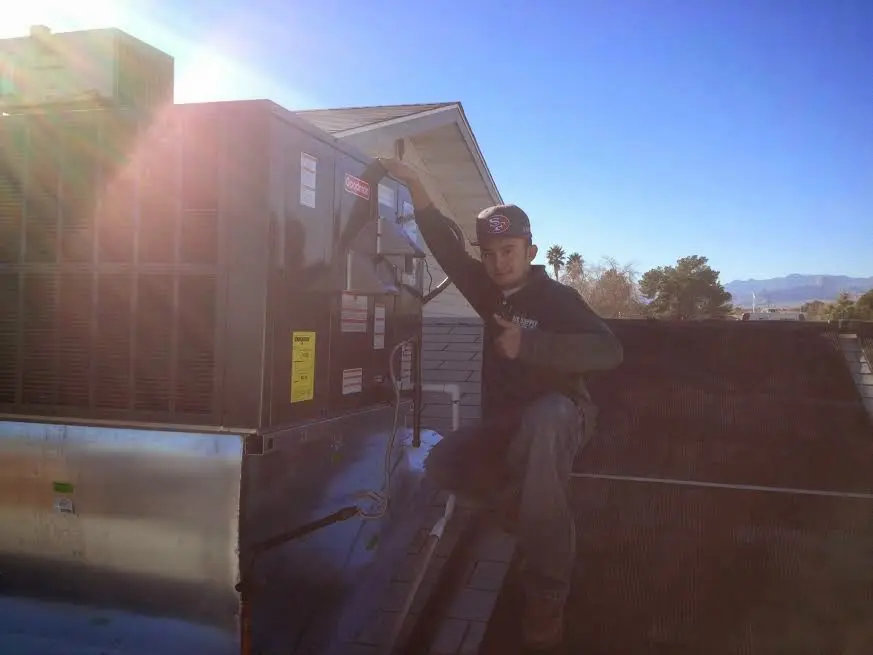 HVAC technician performing HVAC Inspection on a rooftop unit in Chicago Heights